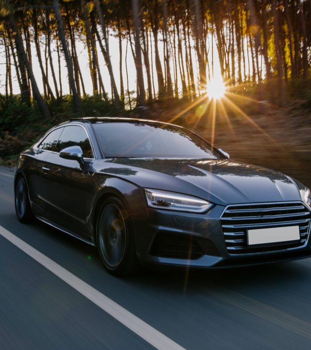 black-sport-car-highway-drive-sunset